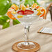 An Acopa Colossal martini glass with a shrimp and sauce in it.
