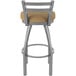 A stainless steel Holland Bar Stool outdoor counter stool with a tan cushion.
