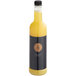 A clear plastic bottle of Twisted Alchemy Cold-Pressed Pineapple Juice with a black cap filled with yellow liquid.