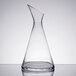 A clear glass carafe with a slanted top.