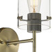 A Globe Vintage Antique Brass wall sconce with clear glass shade.