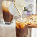 A glass of iced coffee with So Delicious Organic Unsweetened Vanilla Coconut Milk and cookies.