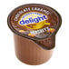 A brown International Delight container of Hershey's Chocolate Caramel non-dairy creamer.