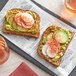 A slice of bread with avocado and radish on top.