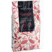 A black bag of Valrhona Guanaja 70% dark chocolate feves with white and red text.