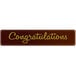 A brown rectangular Chocolatree chocolate decoration with gold text that says "Congratulations"