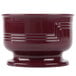 A close up of a Cambro cranberry bowl with a red rim.