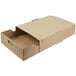 A brown cardboard box with an open lid containing a clear plastic tray lid.