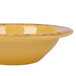 A yellow Venetian melamine bowl with a colorful design on it.
