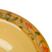 A yellow Venetian melamine bowl with a floral design.