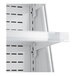 A white vertical air curtain merchandiser shelf with holes.
