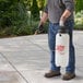 A man using a Chapin Xtreme Poly Concrete Sprayer to spray a patio.