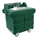 A green plastic Cambro CamKiosk portable self-contained hand sink cart with two sinks on wheels.
