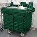 A green plastic Cambro portable hand sink with wheels.
