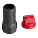 A black and red plastic connector on a black cylinder with a round cap.
