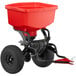 A red Chapin fertilizer spreader with a black handle.