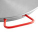 A close up of a Vigor 14" polished carbon steel paella pan with a red handle.