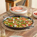A Vigor paella pan of food on a table.