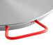 A close up of a Vigor 18" polished carbon steel paella pan with red handles.