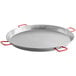 A silver carbon steel paella pan with red handles.