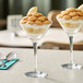An Acopa Select martini glass filled with ice cream and bananas on a table.