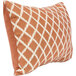 An apricot pillow with a white geometric pattern.