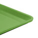 A lime green Cambro dietary tray with a black bottom.