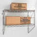 A Metro Erecta chrome wire shelf with boxes on it.