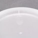 A white plastic Newspring deli container lid with a white circle.