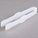 A pair of white plastic Fineline Tiny Tongs.