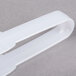 White plastic tongs with a handle.