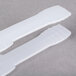 White plastic tongs with two plastic strips on the ends.