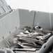 A gray plastic Vollrath Tote 'N Store buffetware box full of silverware.