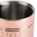 A hammered copper-plated stainless steel wine cooler with a hole in the bottom.