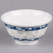 A white melamine bowl with blue dragon designs.