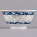 A close-up of a Thunder Group Blue Dragon melamine rice bowl with blue and white designs.