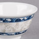 A white melamine bowl with a blue dragon design on it.