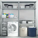 An AR Shelving galvanized metal bolted shelving unit in a laundry room with a washing machine.