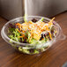 A salad in a Fineline clear plastic bowl.