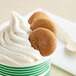 A cup of ice cream with a Homefree Gluten-Free Mini Ginger Snap Cookie on top.