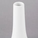 A close-up of a European white porcelain bud vase.