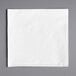 A 12" x 12" white premium luncheon napkin on a gray surface.