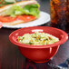 A red GET Diamond Harvest melamine bowl filled with pasta.