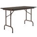 A walnut Correll rectangular folding table with a black top.