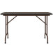 A Correll rectangular table with metal legs and a walnut top.