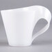 A white Fineline plastic cup with a handle.