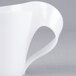 A white plastic cup with a curved handle.