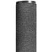 A black cylindrical Notrax entrance floor mat with a round top on a grey surface.