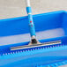 A blue Lavex window mop with a handle in a blue bucket with a handle.