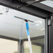 A Lavex window cleaning machine with a blue handle and squeegee attachment.